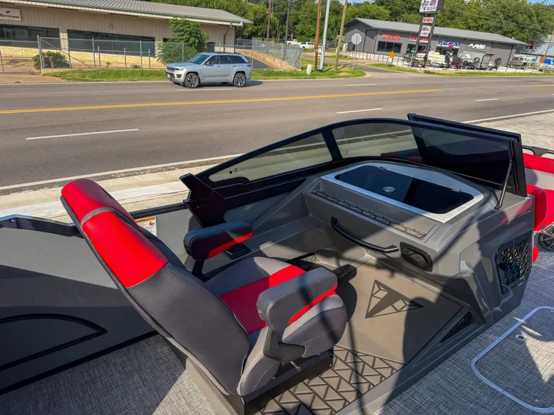 Slide: The Image of The image shows the cockpit of a 2025 Trifecta 25 SPORT RF9 DC 3.0 ARCH boat with red and black seats. - 23