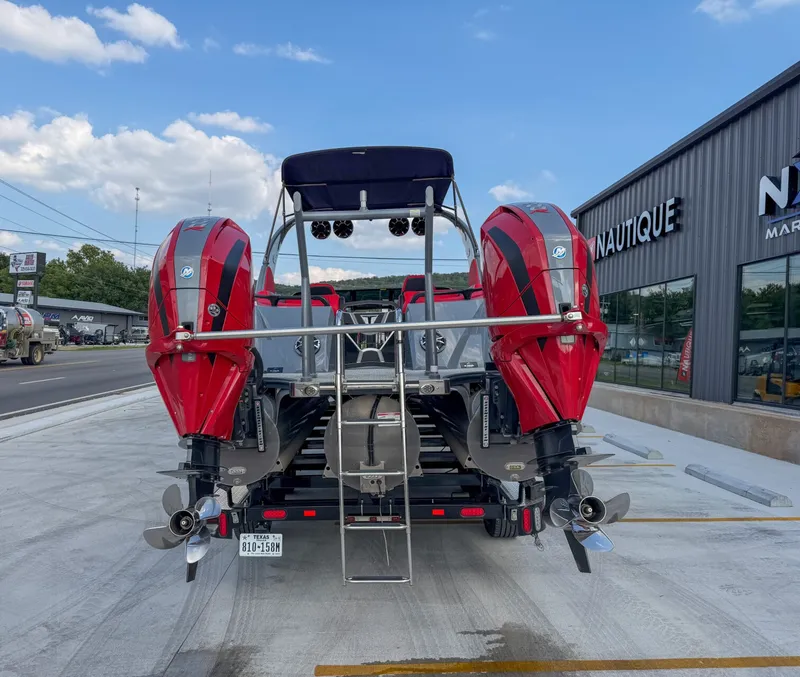 Slide: The Image of A Trifecta 25 SPORT RF9 DC 3.0 ARCH with two red outboard motors on a parking lot. - 5