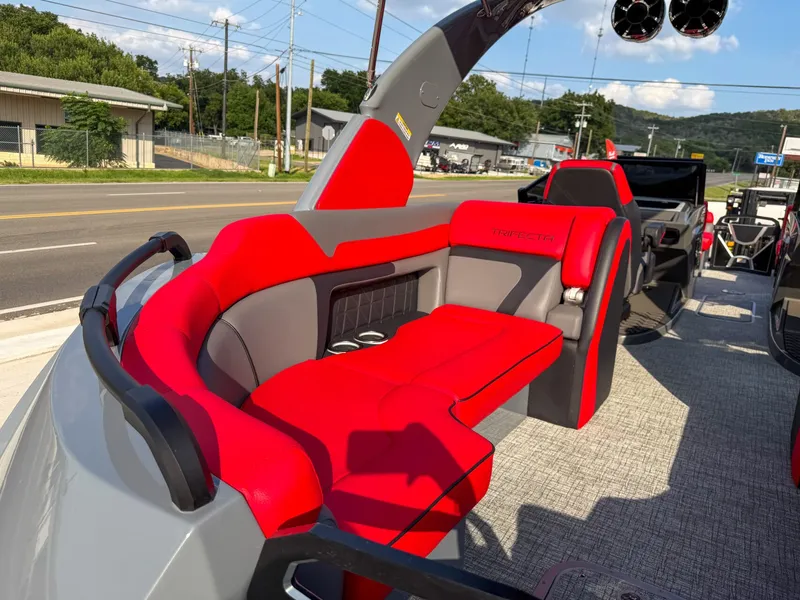 Slide: The Image of The image shows the interior of a 2025 Trifecta 25 SPORT RF9 DC 3.0 ARCH boat with red and gray seating. - 22