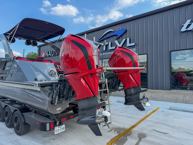 Slide: The Image of A Trifecta 25 SPORT RF9 DC 3.0 ARCH boat with two red outboard motors on a trailer. - 4