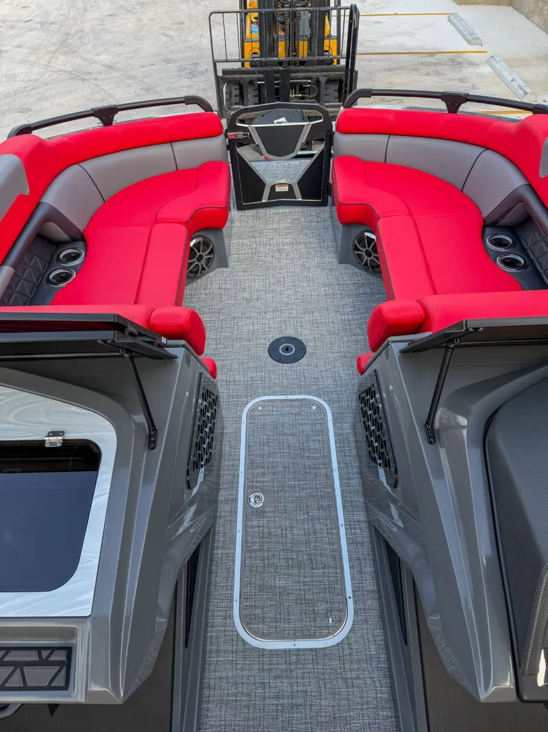 Slide: The Image of The image shows the interior of a 2025 Trifecta 25 SPORT RF9 DC 3.0 ARCH boat with red seating. - 9