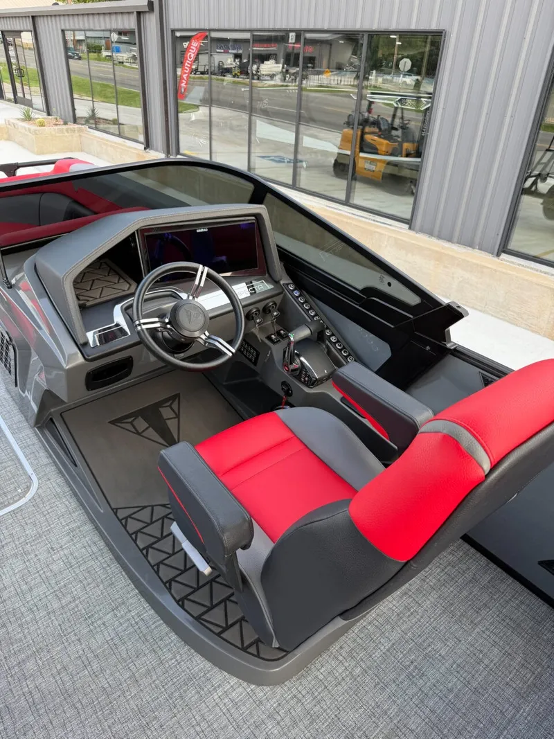 Slide: The Image of The image shows the cockpit of a 2025 Trifecta 25 SPORT RF9 DC 3.0 ARCH boat with a modern helm and red seats. - 11