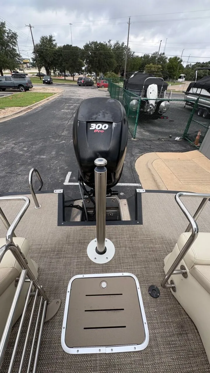 Slide: The Image of The image shows the stern of a Bennington 2575 QCW pontoon boat with a 300 HP outboard motor. - 12