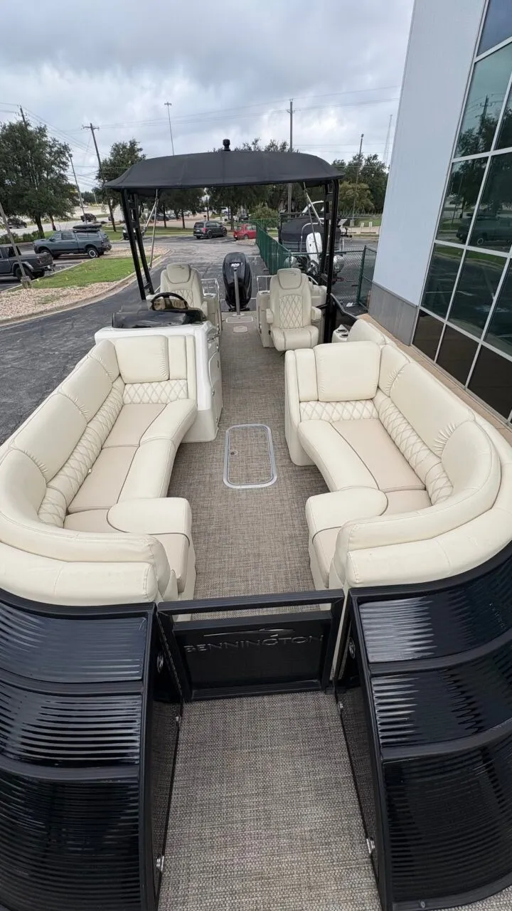 Slide: The Image of A 2015 Bennington 2575 QCW pontoon boat with beige leather seating and black railing. - 9