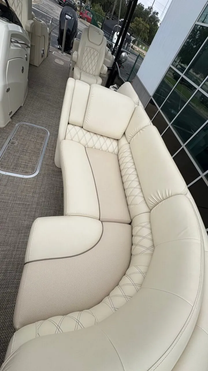 Slide: The Image of The image shows the luxurious cream-colored seating of a 2015 Bennington 2575 QCW. - 10