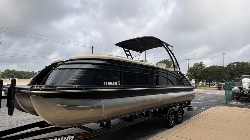 Slide: The Image of A 2015 Bennington 2575 QCW pontoon boat on a trailer, ready for transport. - 6