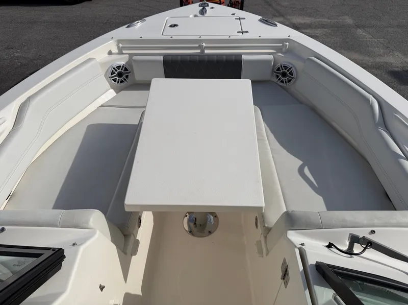 Slide: The Image of The image shows the bow area of a 2021 Cobia 240 Dual Console boat with seating and a table. - 6
