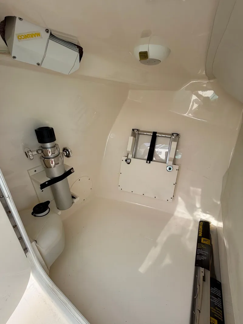 Slide: The Image of Interior of a 2021 Cobia 240 Dual Console with clean, white finish and accessories. - 27