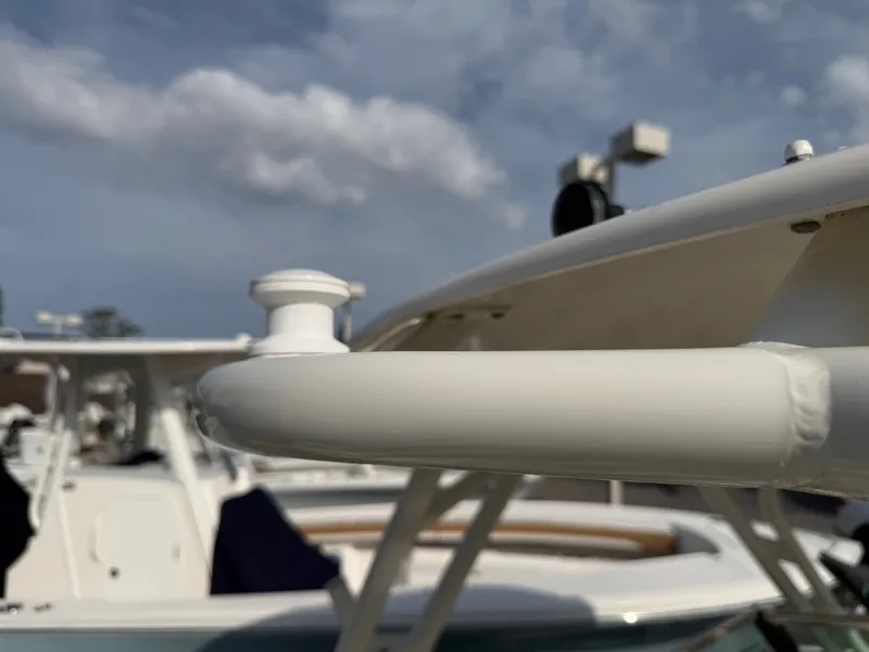 Slide: The Image of Close-up of a boat detail with a white railing and blue sky in the background. - 29