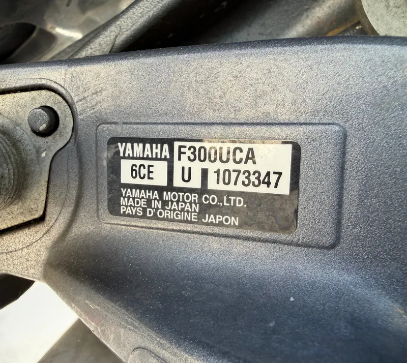Slide: The Image of Close-up of a Yamaha F300UCA engine plate on a Cobia 240 Dual Console boat. - 34