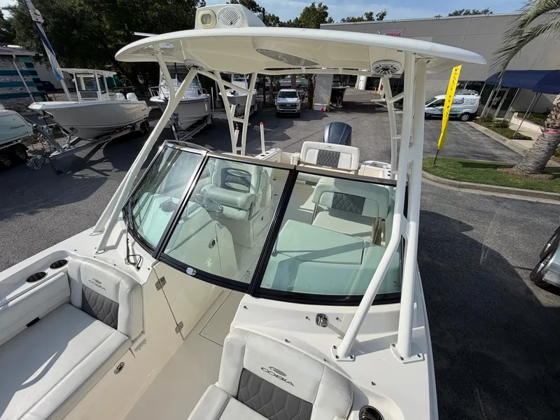 Slide: The Image of The image shows a 2021 Cobia 240 Dual Console. It features a spacious cockpit and comfortable seating. - 4