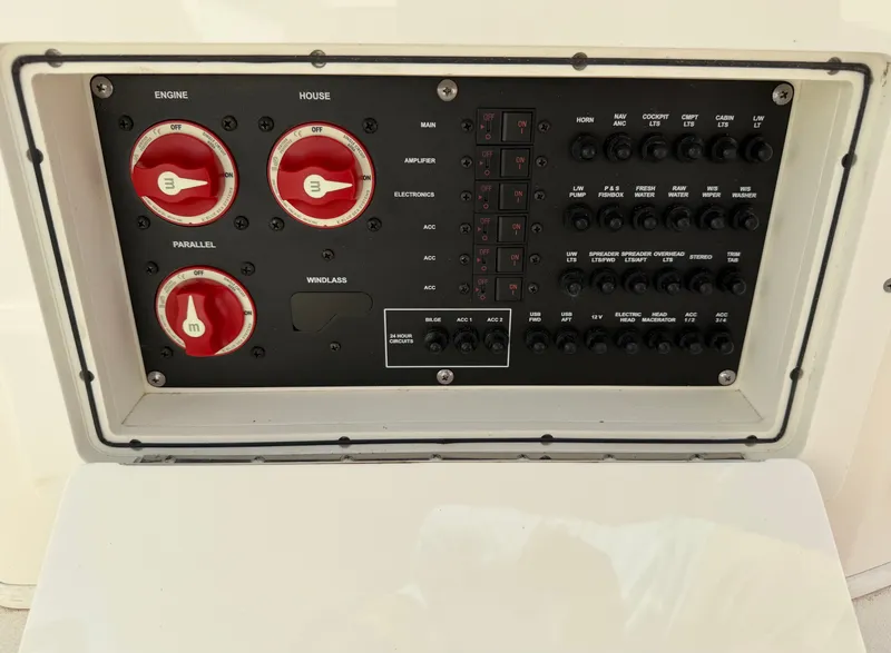 Slide: The Image of The image shows an electrical control panel on a 2021 Cobia 240 Dual Console boat. - 23