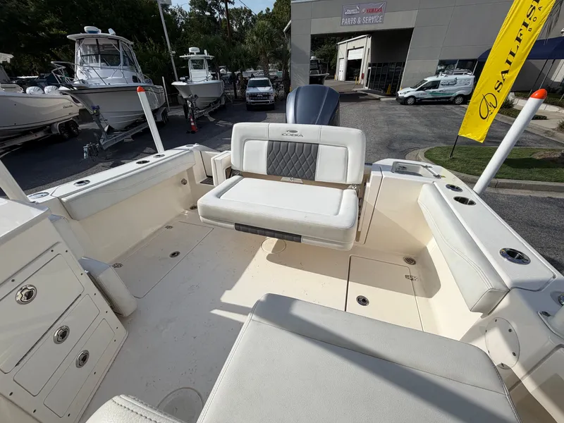 Slide: The Image of The image shows the cockpit of a 2021 Cobia 240 Dual Console boat with seating and storage. - 19