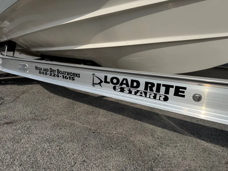 Slide: The Image of A 2021 Cobia 240 Dual Console boat on a Load Rite 5 Starr trailer. - 36