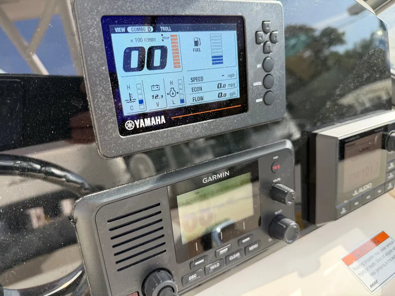 Slide: The Image of The image shows a boat cockpit with Yamaha and Garmin electronics, including a tachometer and radio. - 14