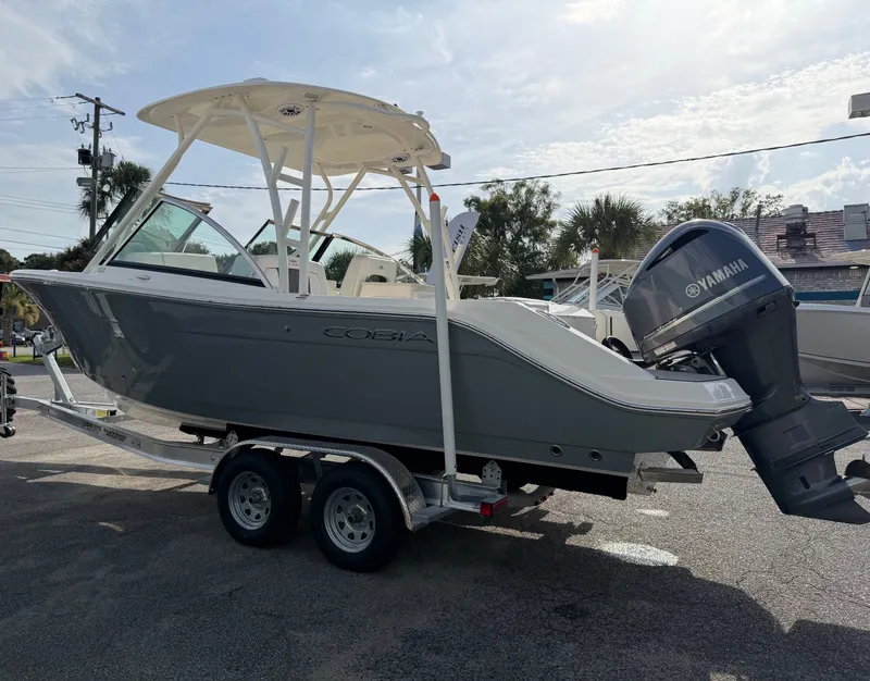Slide: The Image of A gray 2021 Cobia 240 Dual Console boat on a trailer with a Yamaha outboard motor. - 39
