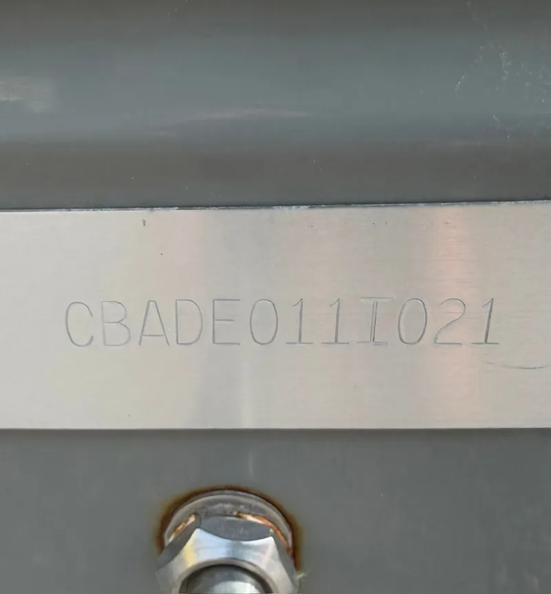 Slide: The Image of Close-up of a serial number on a 2021 Cobia 240 Dual Console boat. - 33