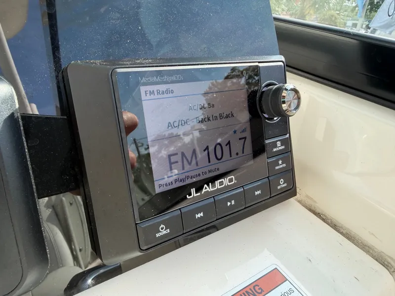 Slide: The Image of A JL Audio radio on a Cobia 240 Dual Console boat displays FM 101.7. - 16