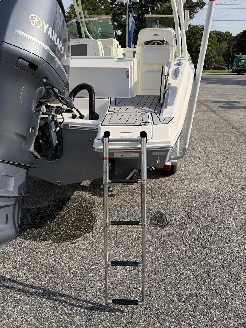 Slide: The Image of The 2021 Cobia 240 Dual Console features a swim platform with a retractable ladder and Yamaha engine. - 30