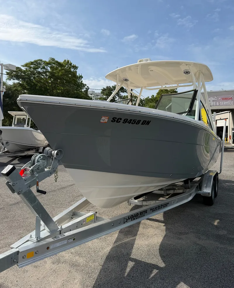 Slide: The Image of A 2021 Cobia 240 Dual Console boat on a trailer. It features a gray hull color. - 35