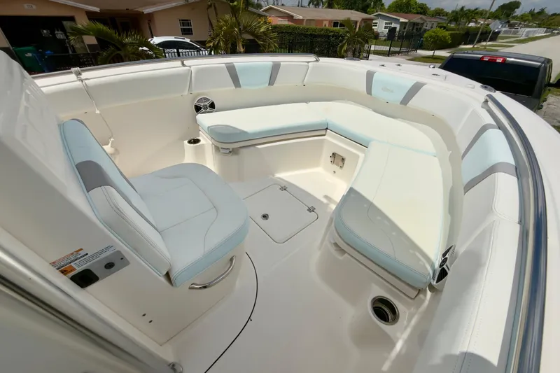 Slide: The Image of 2020 Robalo R230 Center Console boat interior with cushioned seating and storage compartments. - 32