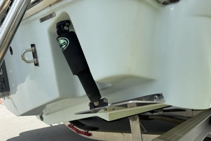 Slide: The Image of 2020 Robalo R230 Center Console boat with trim tab detail. - 57