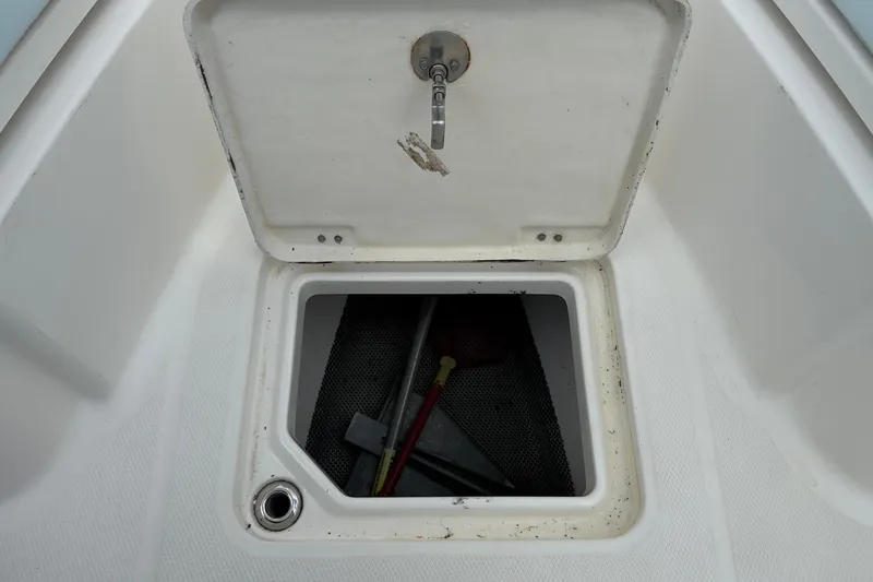 Slide: The Image of Open storage compartment on 2020 Robalo R230 Center Console boat. - 35