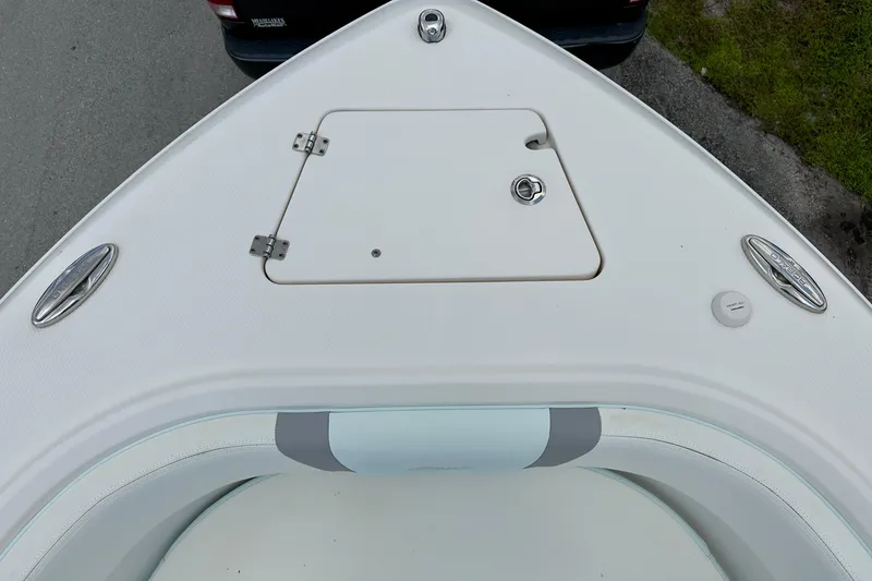 Slide: The Image of 2020 Robalo R230 Center Console boat bow with storage hatch and seating. - 33