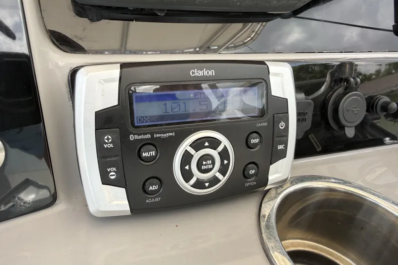 Slide: The Image of Clarion audio system on 2020 Robalo R230 Center Console boat dashboard. - 10