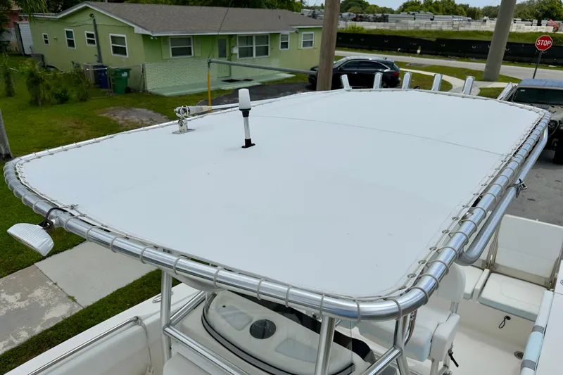 Slide: The Image of 2020 Robalo R230 Center Console boat with T-top, parked in residential area. - 40