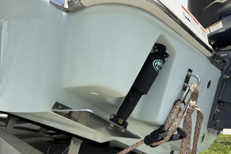 Slide: The Image of 2020 Robalo R230 Center Console boat stern with trim tab and rope detail. - 56