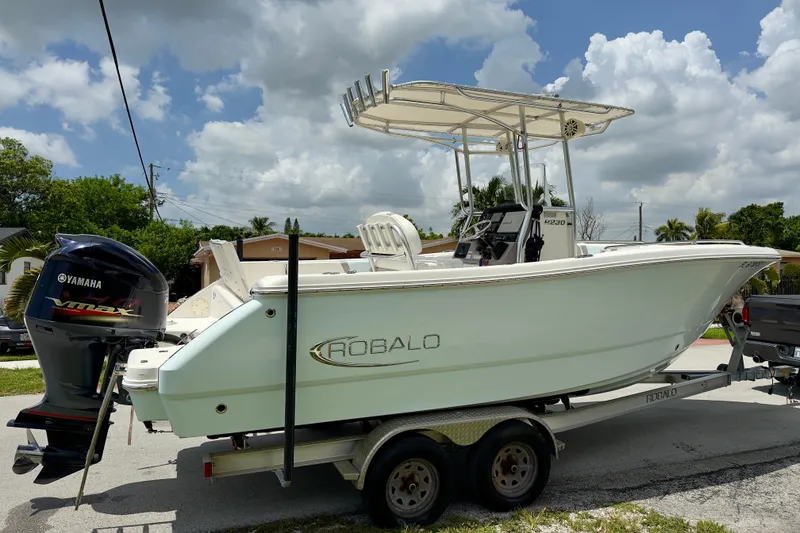 Slide: The Image of 2020 Robalo R230 Center Console boat on trailer with Yamaha engine, parked outdoors. - 50