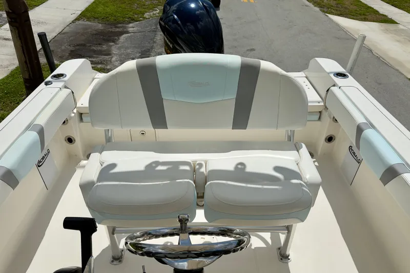 Slide: The Image of 2020 Robalo R230 Center Console boat interior with cushioned seating and steering wheel. - 21