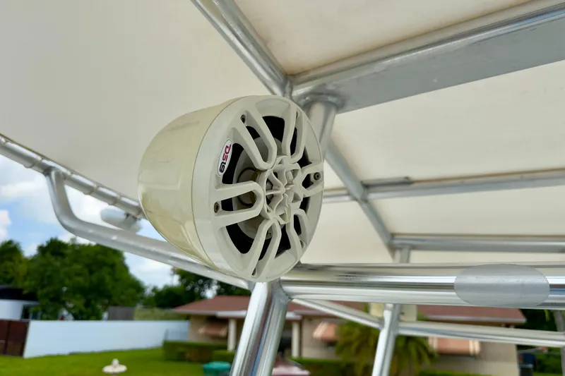 Slide: The Image of Speaker mounted on a 2020 Robalo R230 Center Console boat's T-top frame. - 44