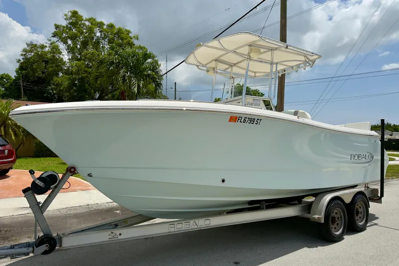 The Image of 2020 Robalo R230 Center Console boat on trailer, parked outdoors. - 0