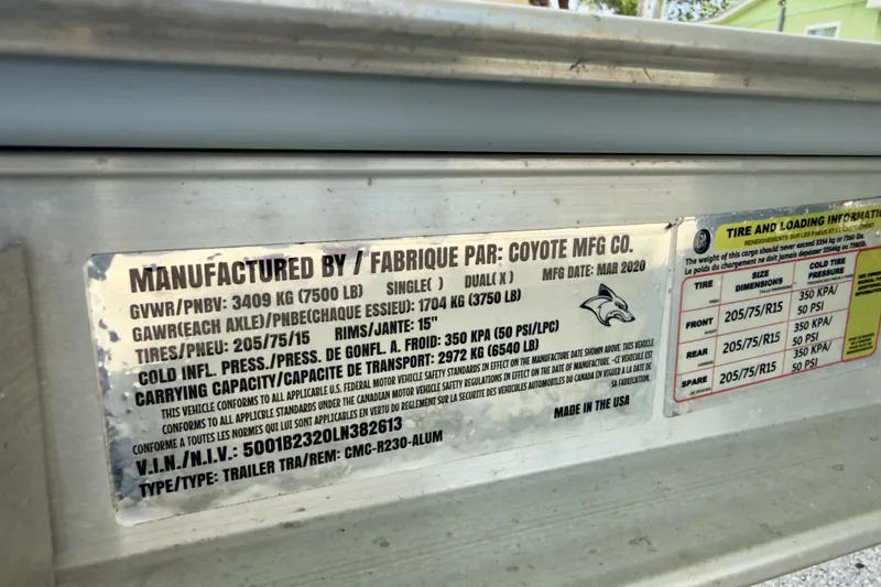 Slide: The Image of Label on a 2020 Robalo R230 Center Console trailer, detailing weight and tire specifications. - 65