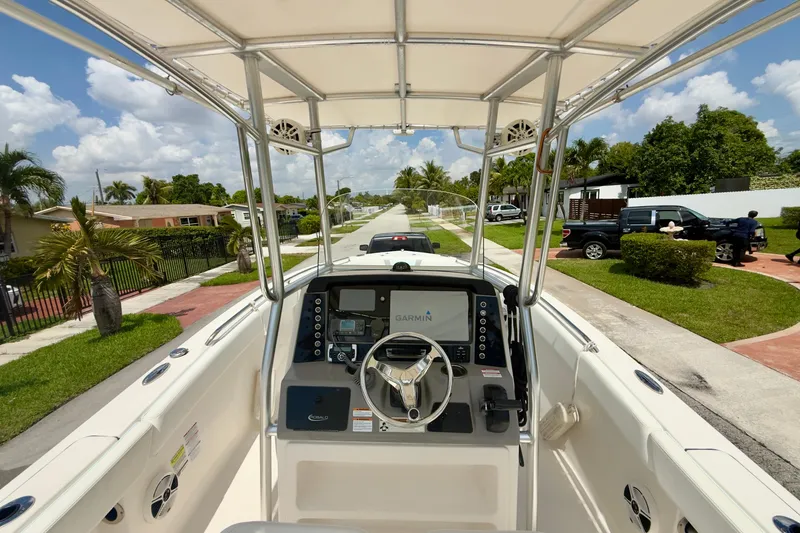 Slide: The Image of 2020 Robalo R230 Center Console boat on a sunny residential street. - 5