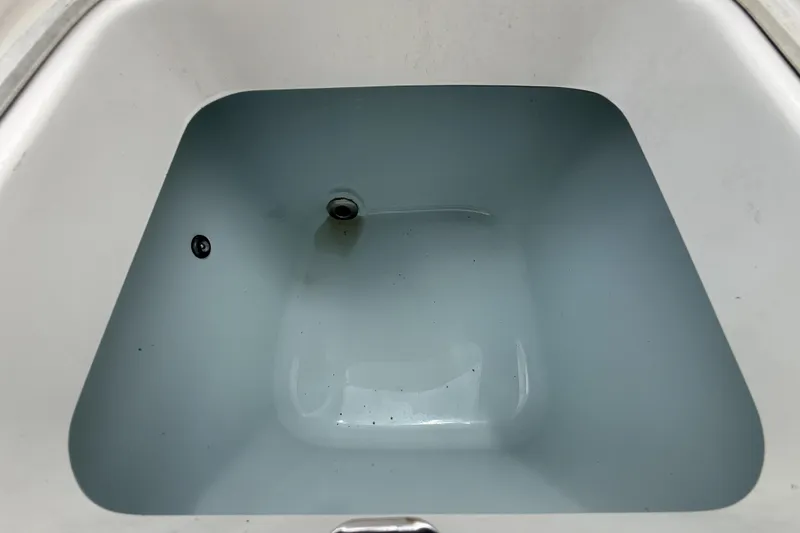 Slide: The Image of Livewell compartment in 2020 Robalo R230 Center Console boat, partially filled with water. - 26