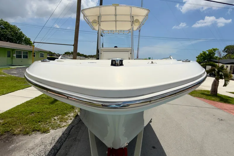 Slide: The Image of 2020 Robalo R230 Center Console boat on trailer, sunny day, residential background. - 62