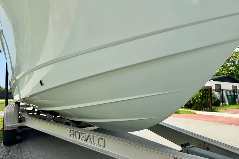 Slide: The Image of 2020 Robalo R230 Center Console boat on trailer, close-up view of hull design. - 60