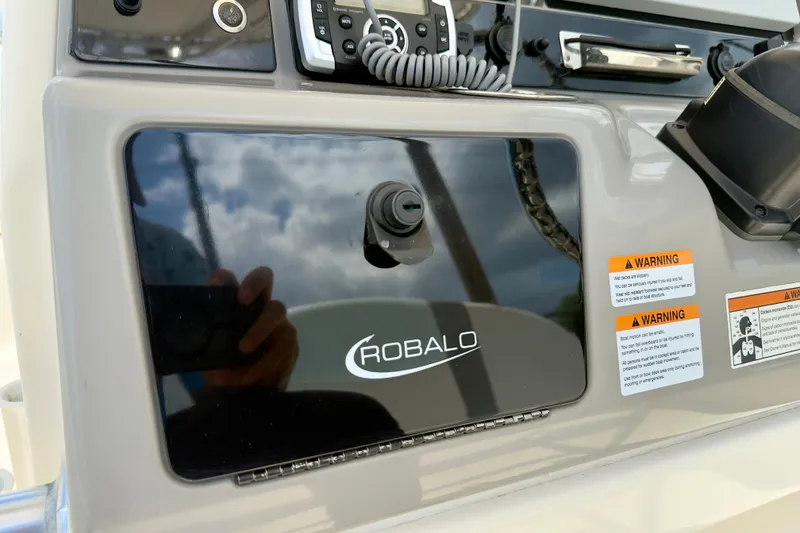 Slide: The Image of 2020 Robalo R230 Center Console dashboard with warning labels and controls. - 9