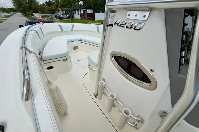 Slide: The Image of 2020 Robalo R230 Center Console boat interior with seating and rod holders. - 29