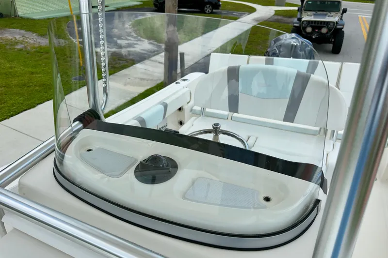 Slide: The Image of 2020 Robalo R230 Center Console boat helm with windshield and steering wheel. - 19