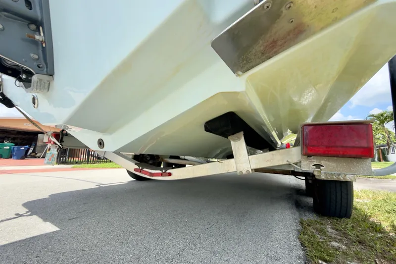 Slide: The Image of 2020 Robalo R230 Center Console boat on trailer, viewed from below. - 59