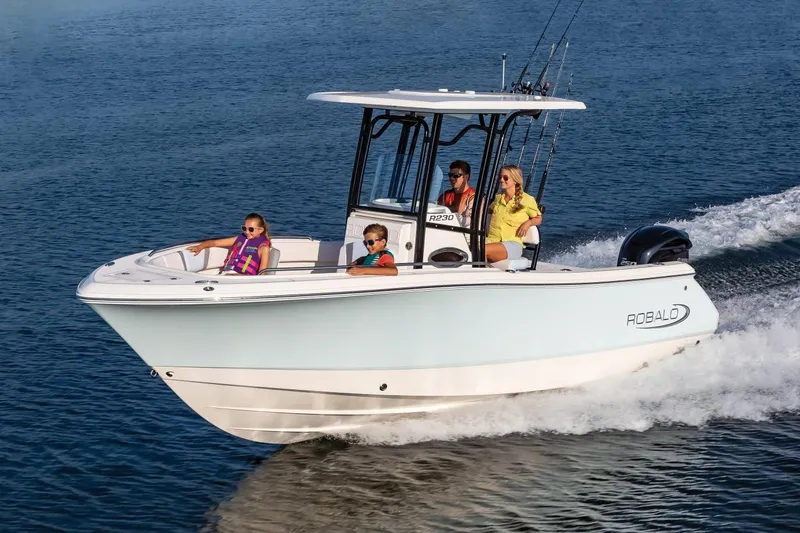 Slide: The Image of Manufacturer Provided Image: 2020 Robalo R230 Center Console boat cruising with passengers on a sunny day. - 66