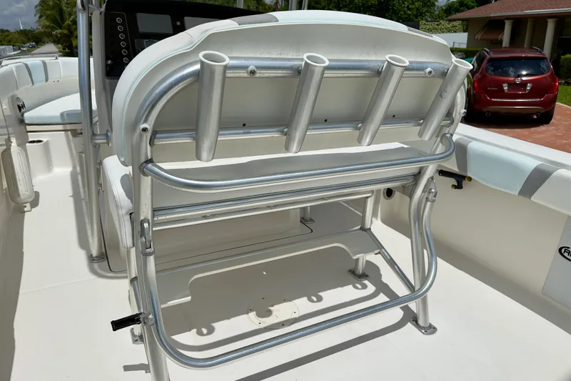 Slide: The Image of 2020 Robalo R230 Center Console boat interior with rod holders and seating. - 23