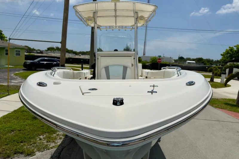 Slide: The Image of 2020 Robalo R230 Center Console boat, front view, parked outdoors under clear sky. - 63