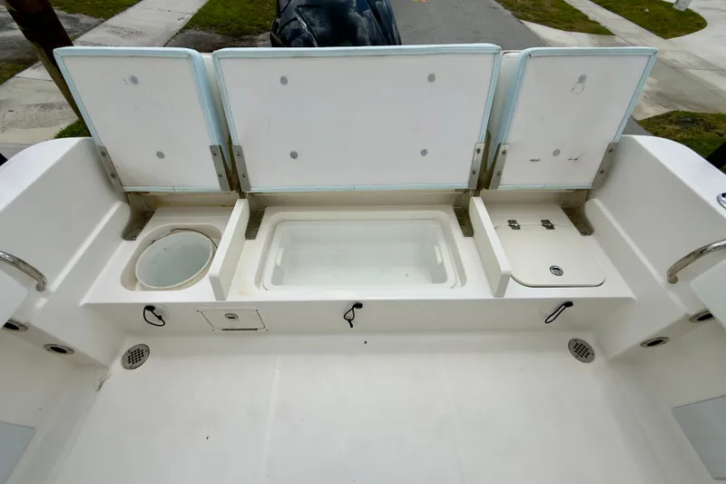 Slide: The Image of 2020 Robalo R230 Center Console boat with open storage compartments and clean deck layout. - 25