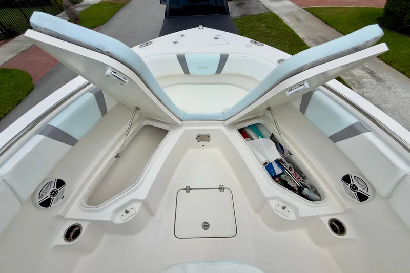 Slide: The Image of 2020 Robalo R230 Center Console boat with open storage compartments and seating. - 31