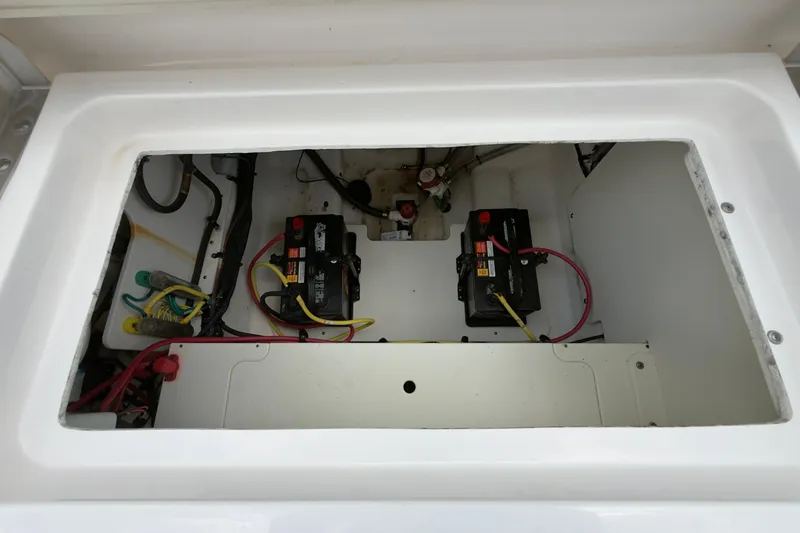 Slide: The Image of Battery compartment of a 2020 Robalo R230 Center Console boat, featuring dual batteries. - 47